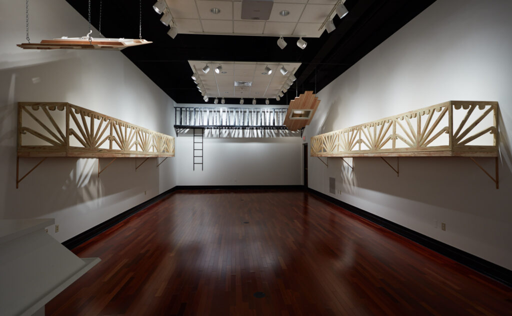 gallery installation with numerous large wall-mounted architectural sculptures