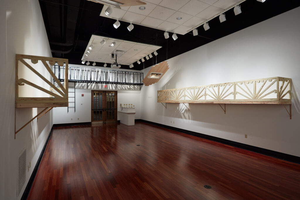 gallery installation with numerous large wall-mounted architectural sculptures
