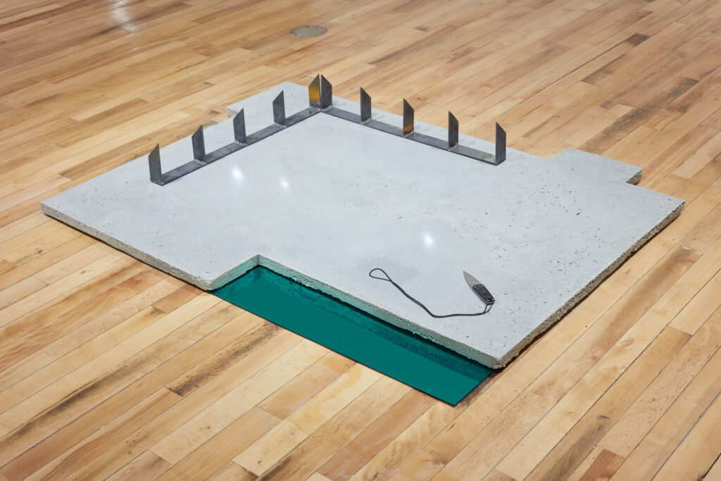 minimalist art installation of concrete and plexiglass contemporary sculpture