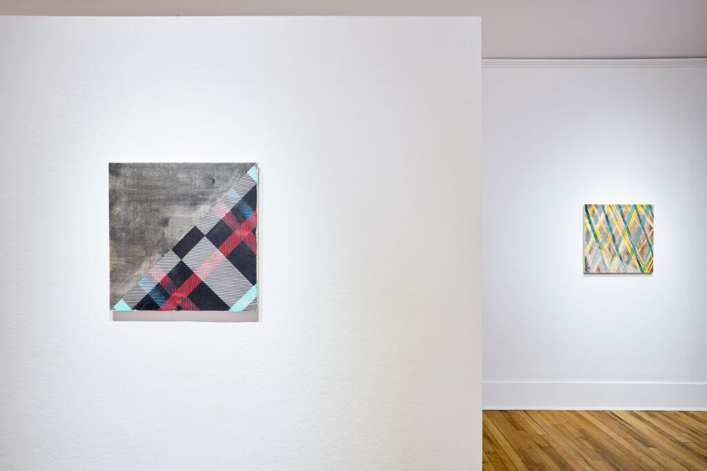 gallery exhibition featuring multi-media paintings and textile art pieces