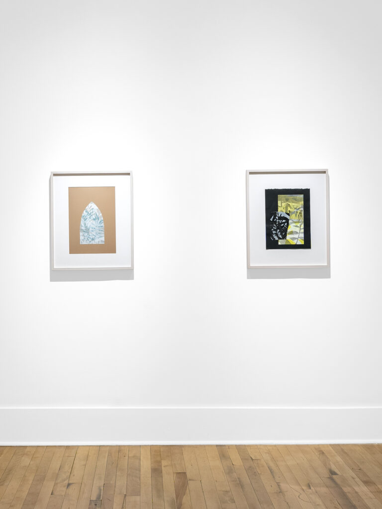 Photograph of two artworks on a white wall with a wooden floor. The right artwork is a small collage of prints on black paper. The print underneath is a vertical rectangle with abstract plant imagery in shades of yellow and gray and there is a small torn print in an amorphous rectangle on top with plant-like imagery in black on light blue-gray. It is in a blonde wood frame. The artwork on the left is a digital print framed in blonde wood. There is a central shape of a church-like window with abstract plant-like imagery in shades of blue with a bronze-gold background color.