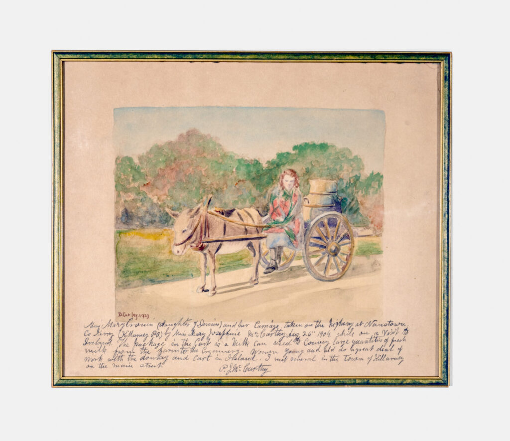 A framed artwork depicting a light-skinned figure sitting on a wooden cart pulled by a donkey. The cart carries a large container. Below is a handwritten caption in cursive.