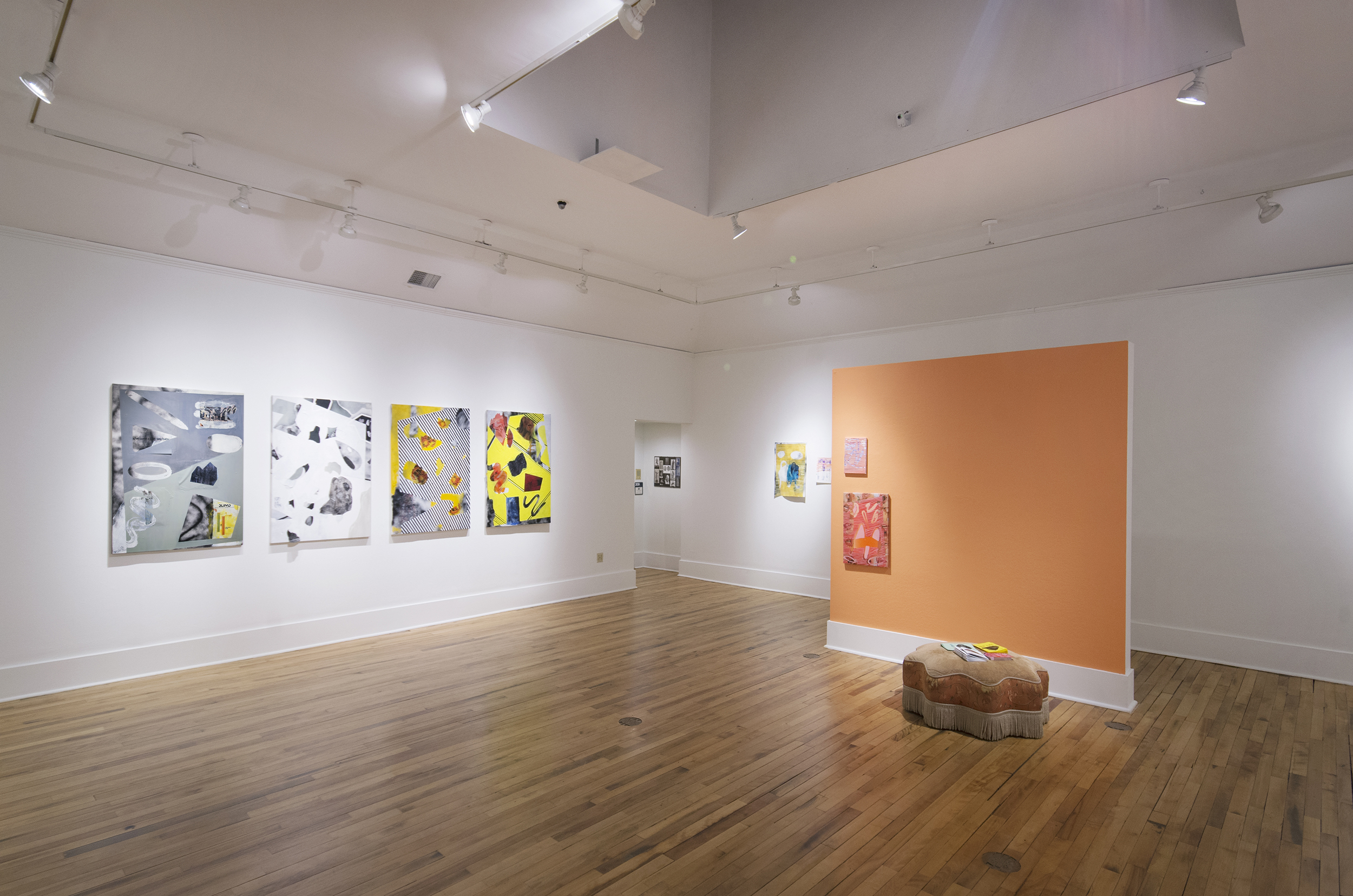 Art exhibition featuring four bright white, gray, and yellow abstract layered artworks on a white wall to your left. An orange wall holds two other artworks.