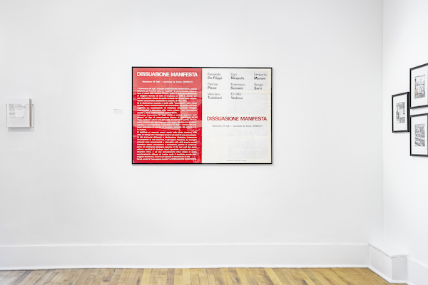 Gallery view of a poster in a black frame with one half colored white and the other red, with the phrase "Dissuasione Manifesta" written on both sides.