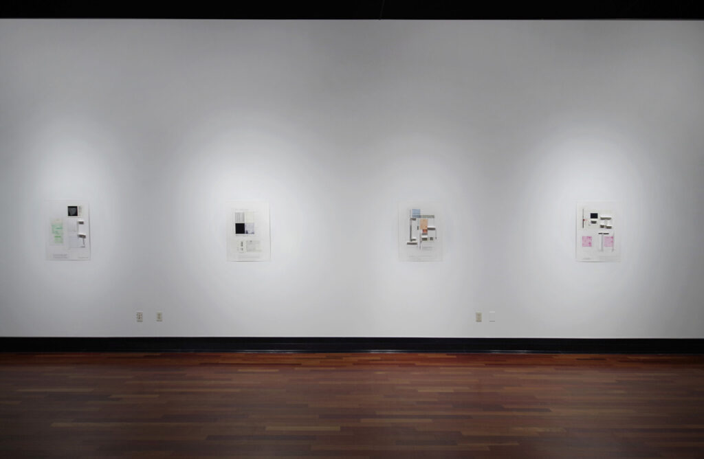 A white gallery wall holding four prints with multicolor squares and rectangles present on each one.