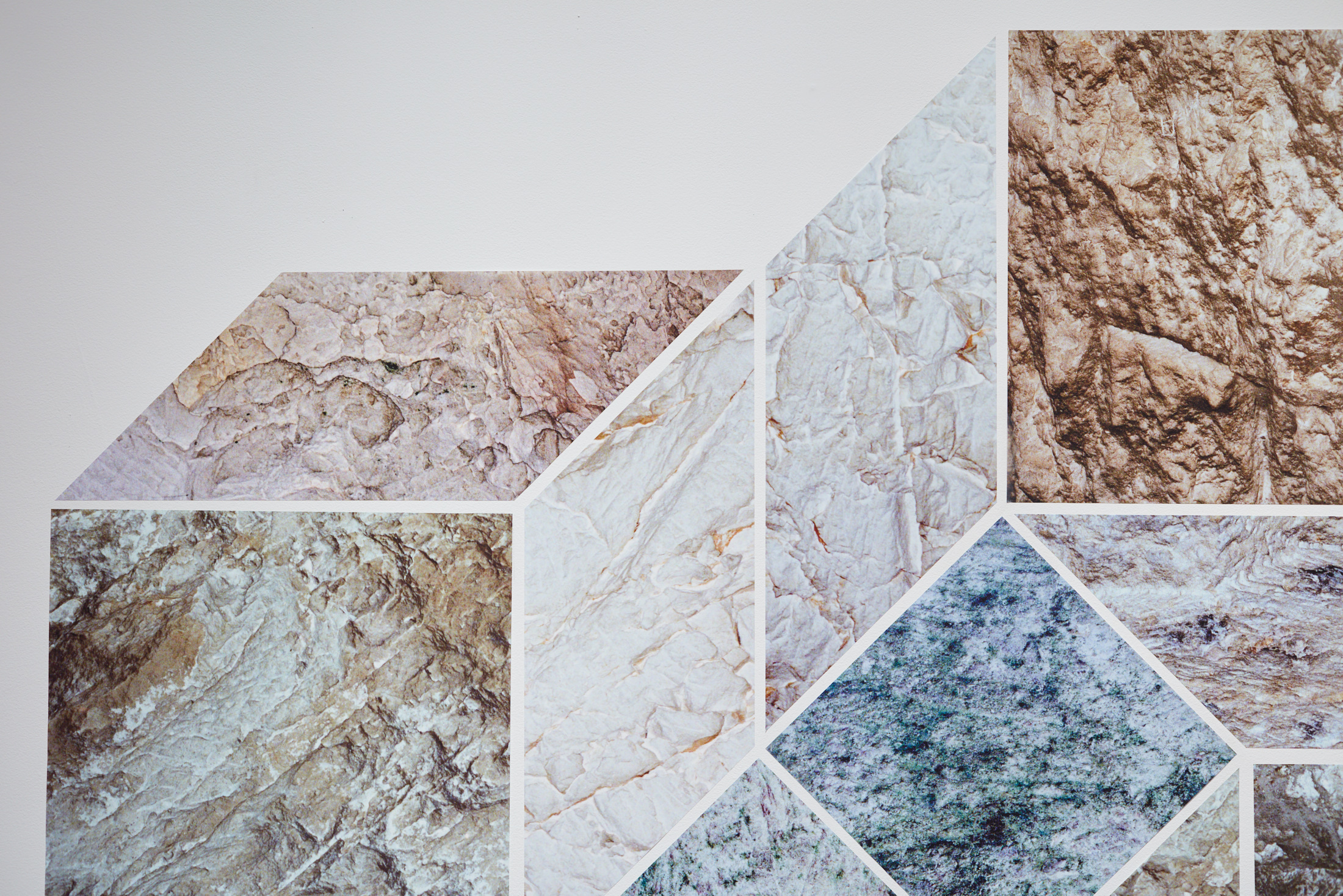 Organically textured design of squares and parallelograms in blue, orange, and beige.