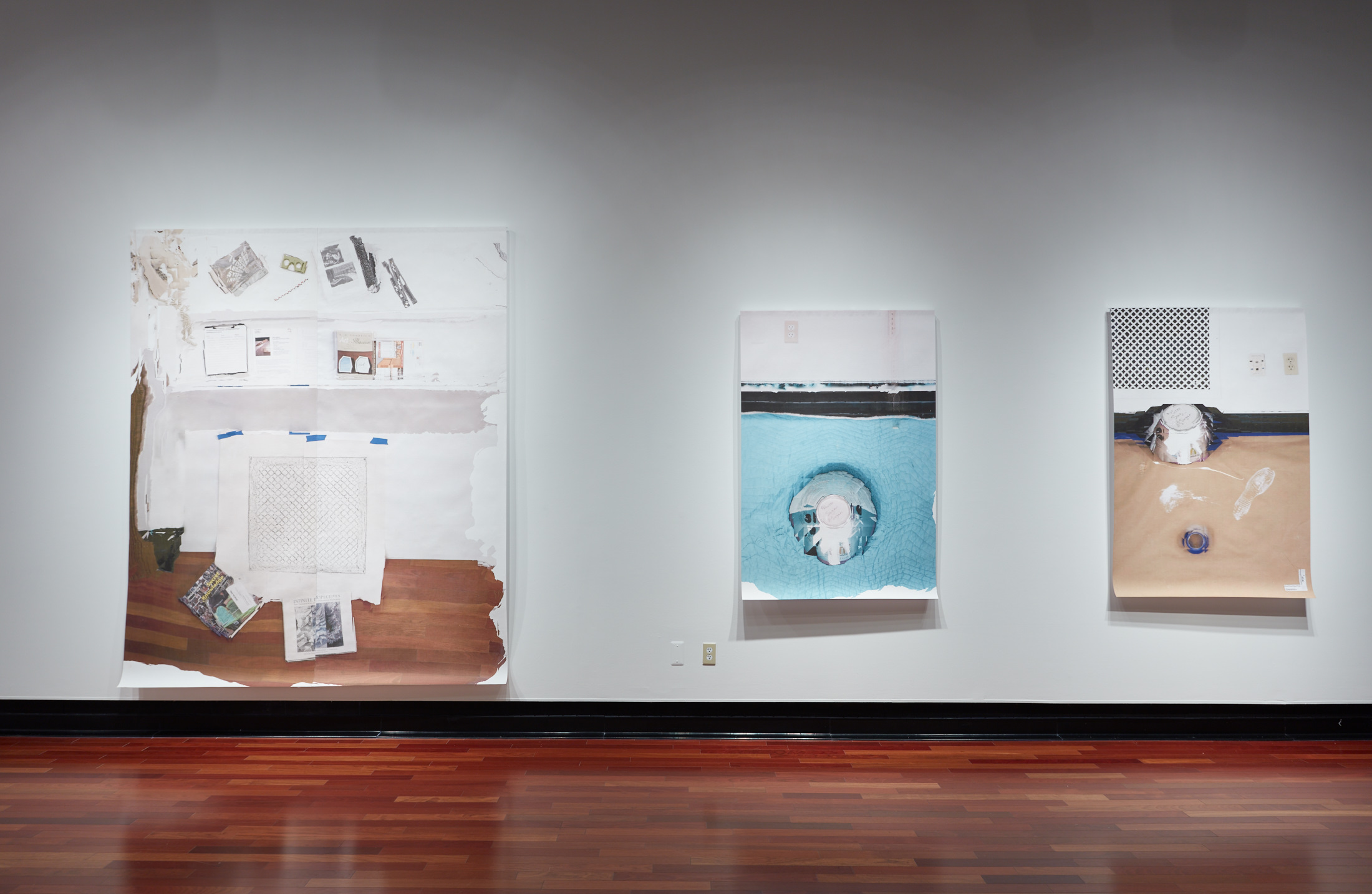 Three canvases on a white gallery wall. They depict painting scenes from within a gallery itself, showing various colors of tape, paint, sketch plans, and the wooden gallery floor.