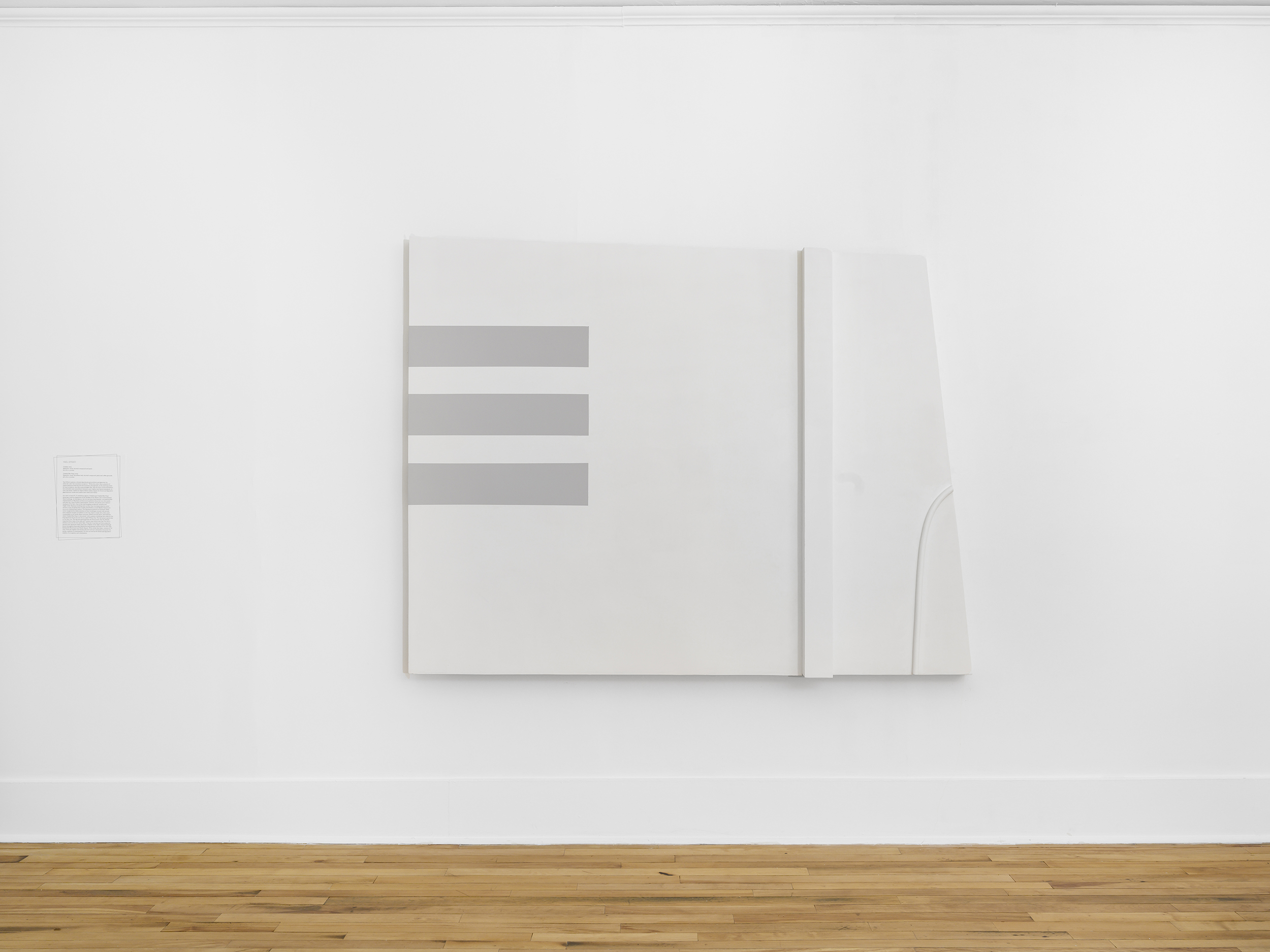 A large rectangular abstract artwork with the right side slanted. It is white with three grey stacked lines on the left. A raised white vertical rectangle is on the right.