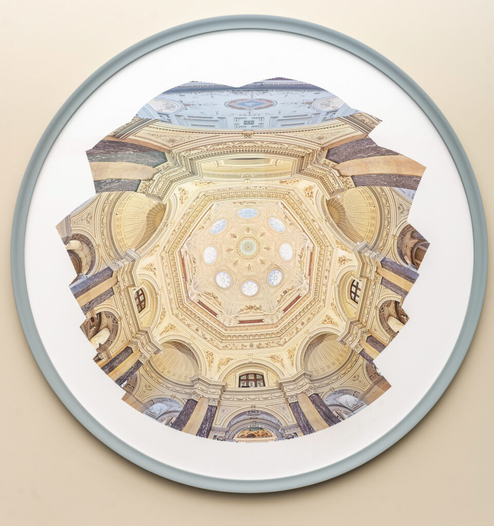 A print looking upwards to the underside of an architectural golden, cream, and blue cathedral dome with eight arched windows and rich ceiling details.