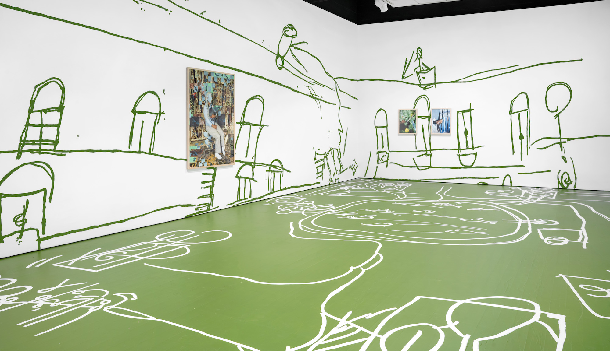 Installation view of white walls decorated with large green abstract sketches. One artwork hangs on the left wall, two on the right. The floor is green with white abstract sketches.