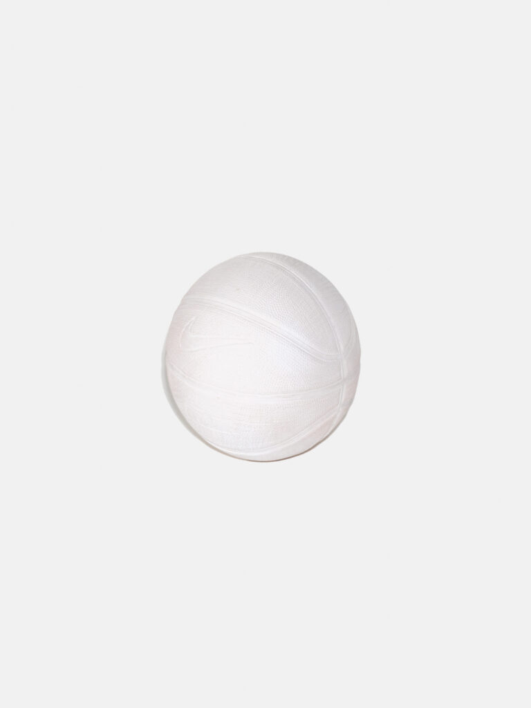An entirely white basketball on a white background. The indentations of lines and the Nike swoosh logo are visible.