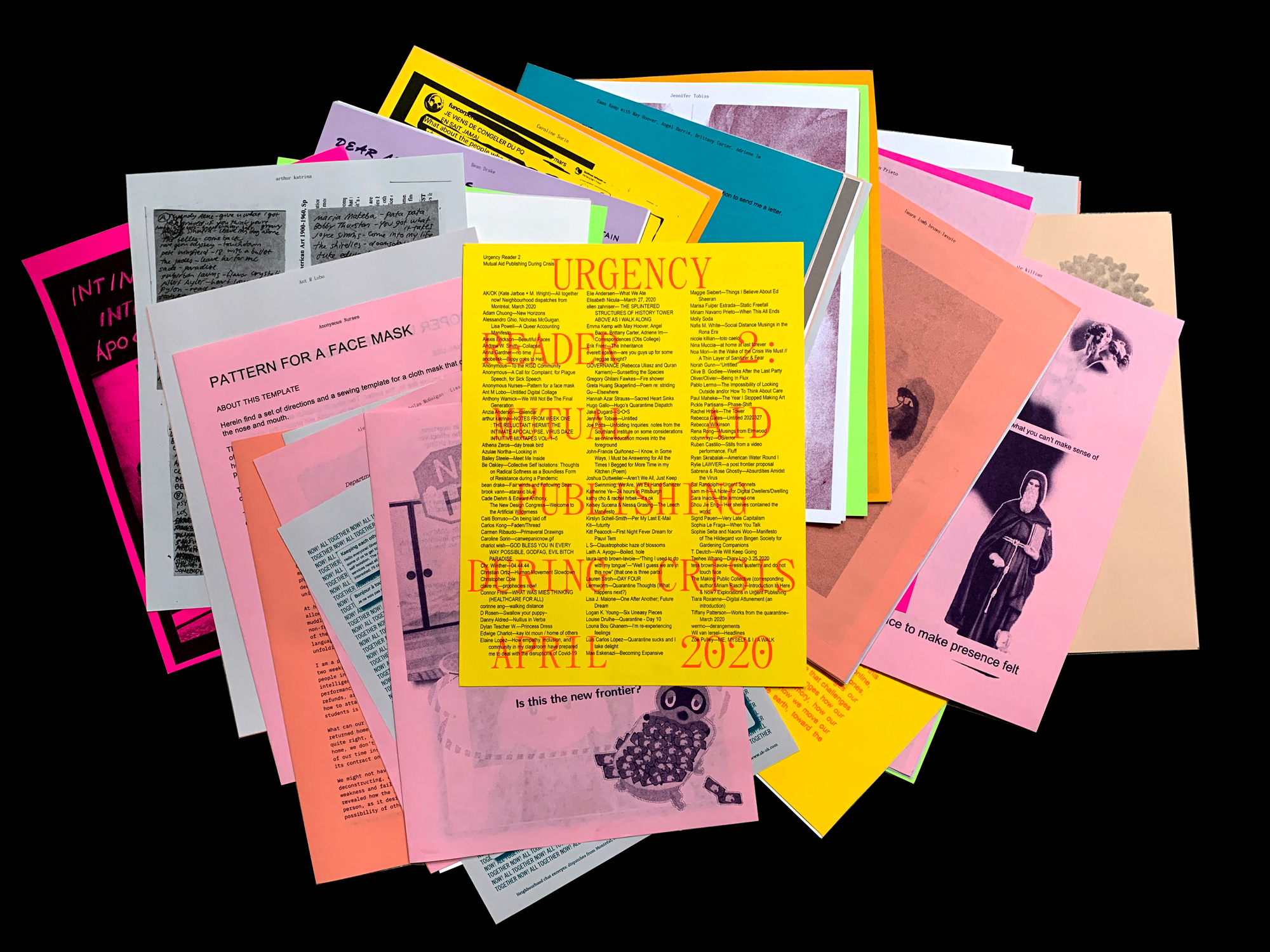A stack of colorful printed papers, including yellow, pink, orange, and gray sheets, with text, images, and drawings spread out on a black background.