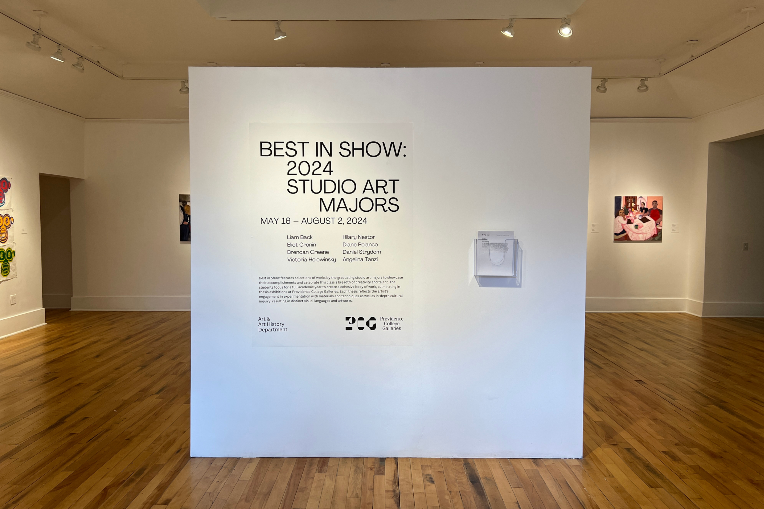 Installation view showing the entrance to a gallery with a white wall reading: Best in Show: 2024 Studio Art Majors. On either side portions of artwork are visible.