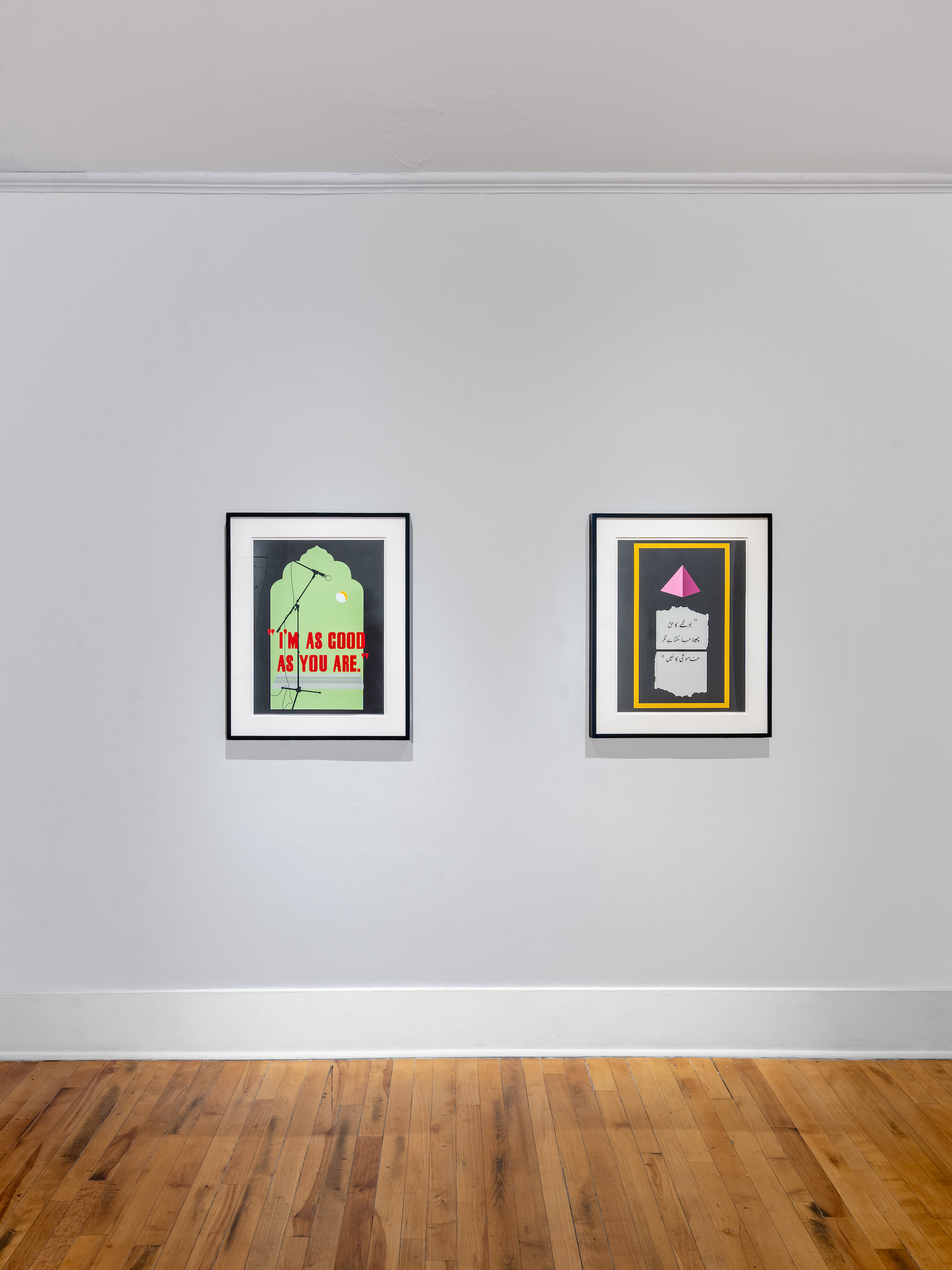Art exhibition featuring two framed screenprints on a grey wall. The left depicts a green shape with red lettering that reads: I'M AS GOOD AS YOU ARE. The right depicts Urdu writing on paper under a pink pyramid.